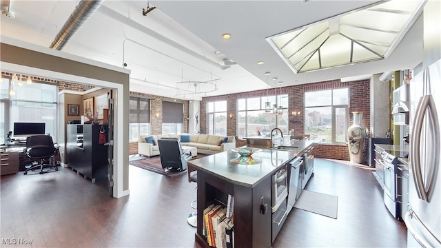 21 Furnace St Unit 705, Akron, OH 44308 - kitchen with a sink, brick wall, dark wood-style floors, open floor plan, and an office area
