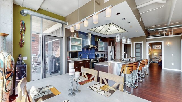 21 Furnace St Unit 705, Akron, OH 44308 - dining space featuring rail lighting, dark wood-type flooring, and baseboards
