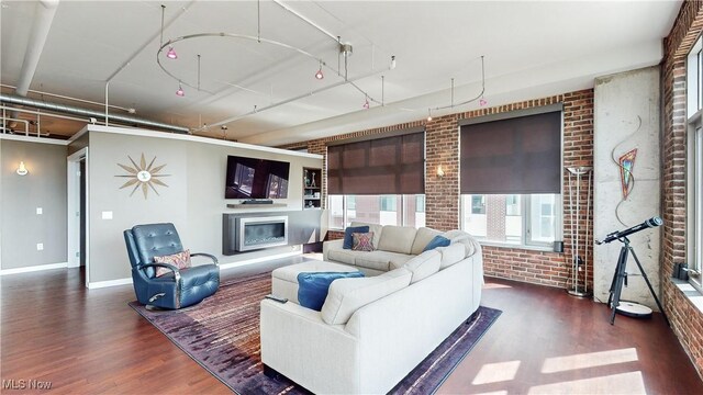 21 Furnace St Unit 705, Akron, OH 44308 - living room with brick wall, wood finished floors, a glass covered fireplace, and baseboards