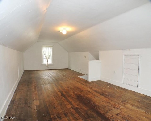 bonus room featuring dark hardwood / wood-style flooring and lofted ceiling