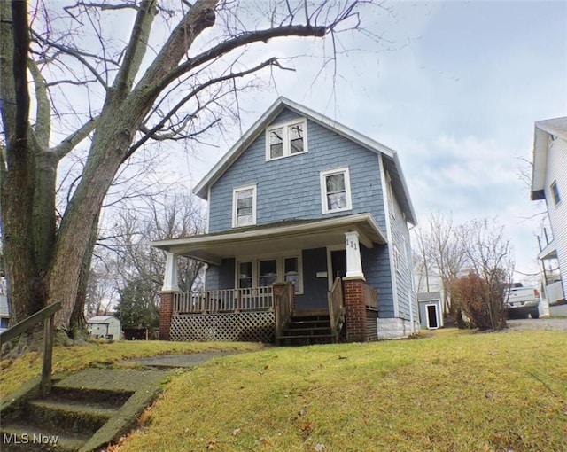 view of front of property with a porch and a front lawn