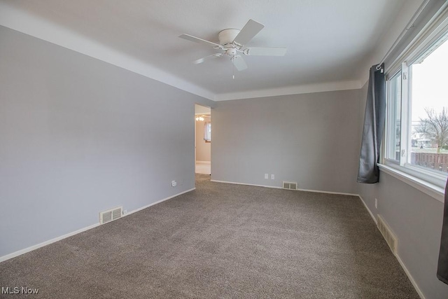 carpeted spare room featuring ceiling fan