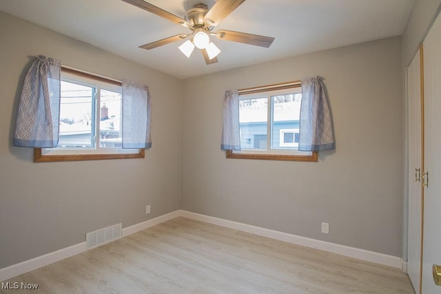 spare room featuring ceiling fan and light hardwood / wood-style floors