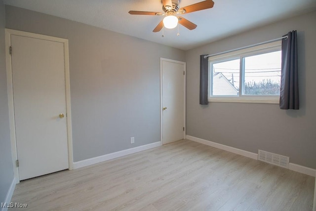 spare room featuring ceiling fan and light hardwood / wood-style floors