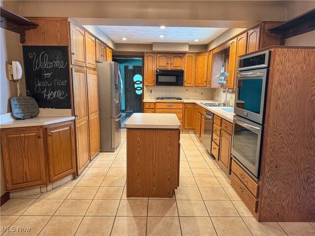 kitchen featuring stainless steel appliances, decorative backsplash, light tile patterned flooring, and a center island