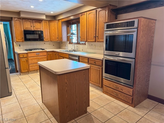 kitchen with light tile patterned floors, sink, stainless steel appliances, and a center island