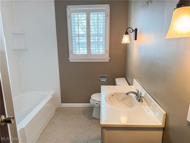 bathroom with vanity, toilet, tile patterned flooring, and a washtub