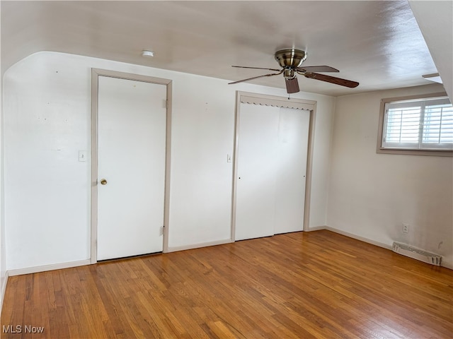 unfurnished bedroom with ceiling fan and light wood-type flooring