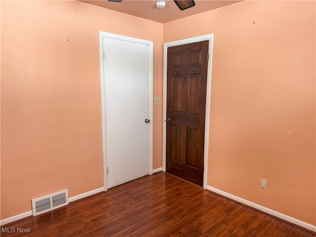 spare room featuring ceiling fan and dark hardwood / wood-style floors