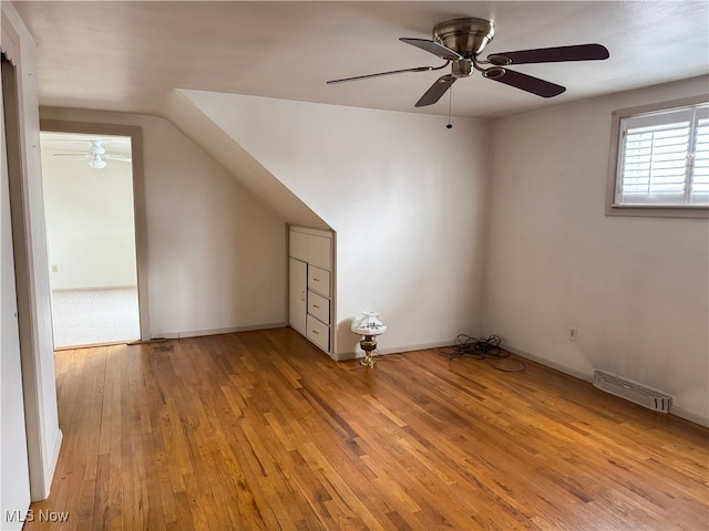 additional living space with light hardwood / wood-style flooring