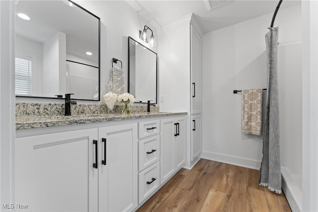 bathroom with hardwood / wood-style floors and vanity