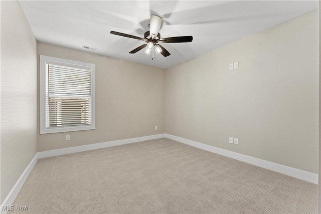 unfurnished room with light carpet and ceiling fan