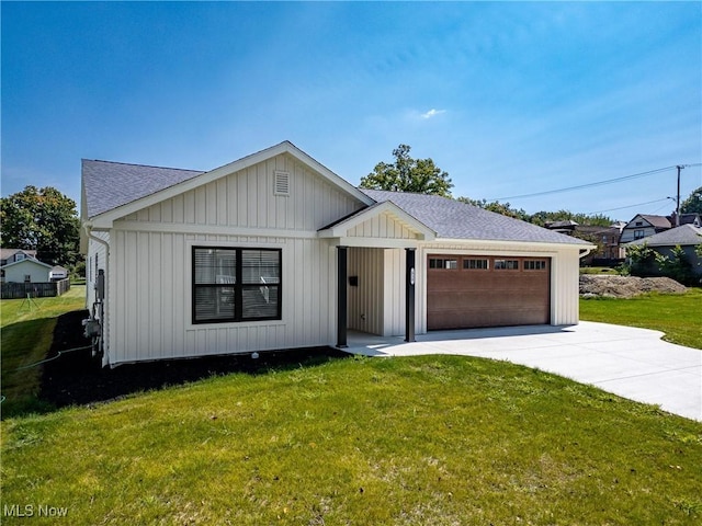 view of front of home with a garage and a front lawn