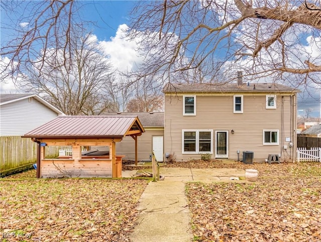 rear view of house with cooling unit and a patio area