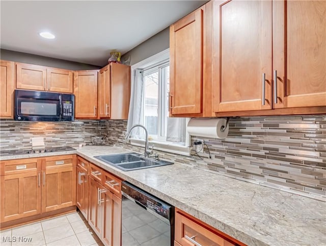 kitchen featuring light tile patterned floors, sink, backsplash, and black appliances