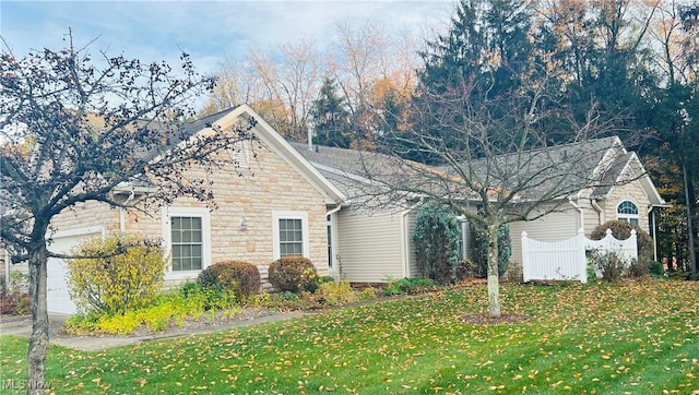 view of front facade with a front yard and a garage