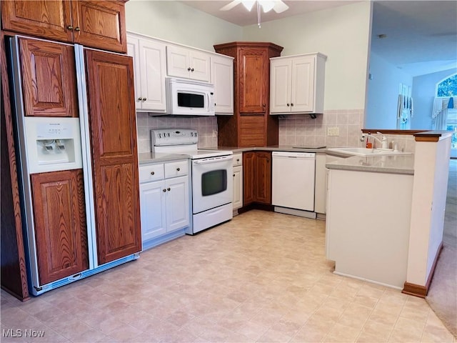 kitchen with decorative backsplash, white cabinetry, white appliances, and sink