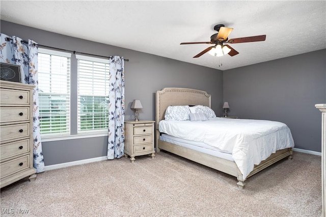 carpeted bedroom with ceiling fan and multiple windows