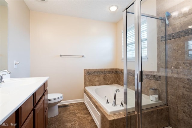 full bathroom featuring vanity, toilet, and independent shower and bath