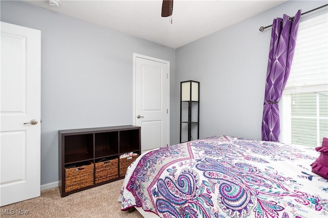 bedroom featuring light colored carpet and ceiling fan