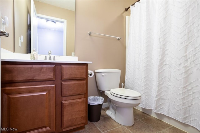 bathroom featuring tile patterned floors, vanity, and toilet