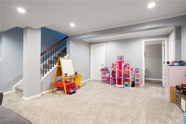 recreation room with carpet flooring and crown molding