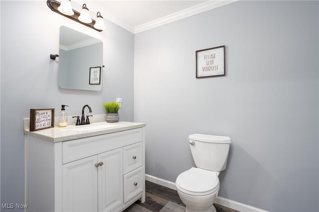 bathroom featuring vanity, toilet, wood-type flooring, and ornamental molding