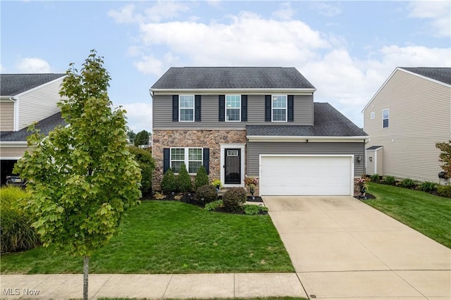 view of front of property featuring a garage and a front lawn