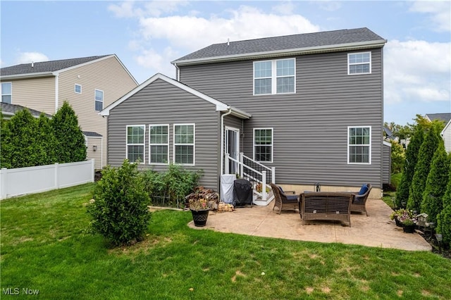 rear view of house with a lawn and a patio area