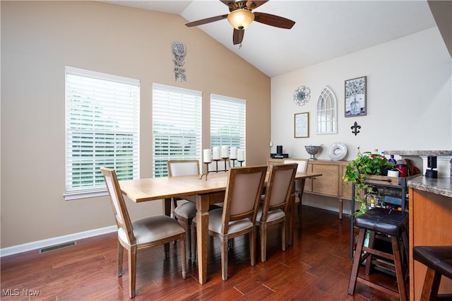 dining space featuring ceiling fan, plenty of natural light, dark wood-type flooring, and vaulted ceiling