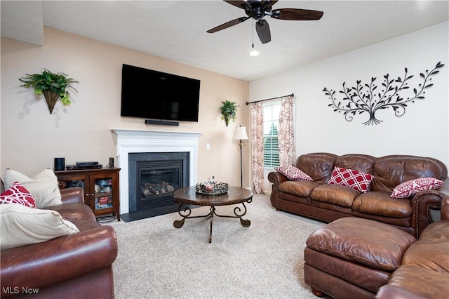 carpeted living room with ceiling fan