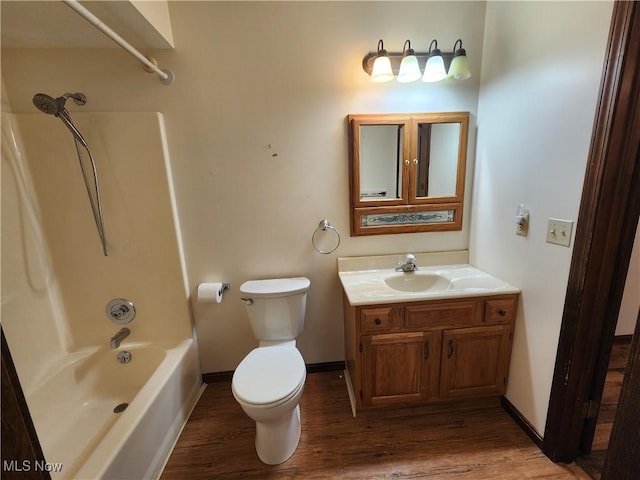 full bathroom featuring vanity, wood-type flooring, bathtub / shower combination, and toilet