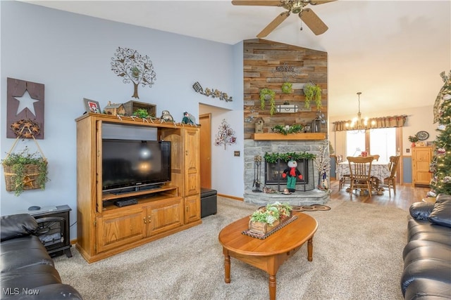 carpeted living room featuring ceiling fan with notable chandelier and lofted ceiling