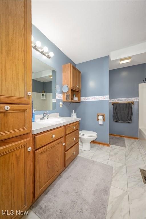 bathroom featuring vanity and toilet