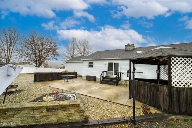 rear view of house featuring a gazebo and a patio area