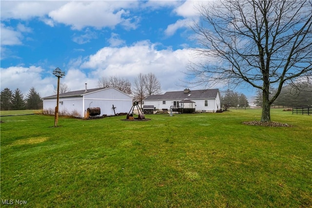 rear view of house with a yard