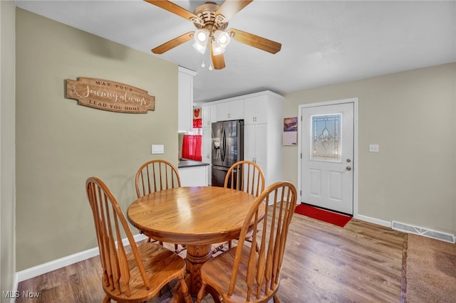 dining area featuring light hardwood / wood-style floors and ceiling fan