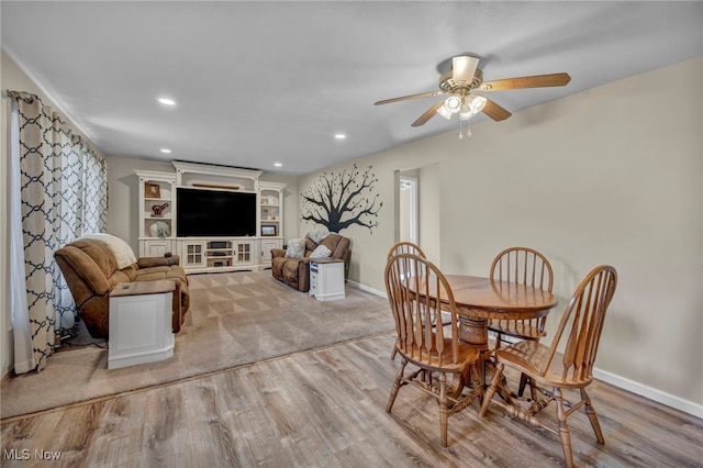 dining space featuring ceiling fan and light wood-type flooring