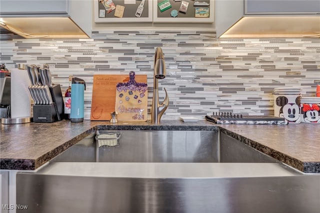 kitchen featuring backsplash and sink