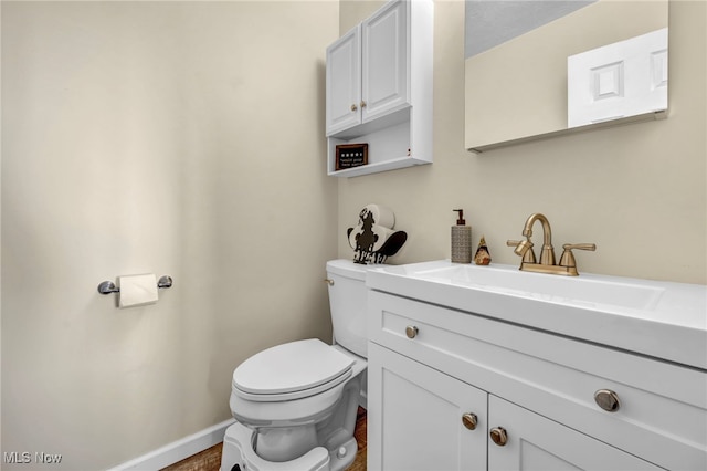 bathroom featuring hardwood / wood-style floors, vanity, and toilet