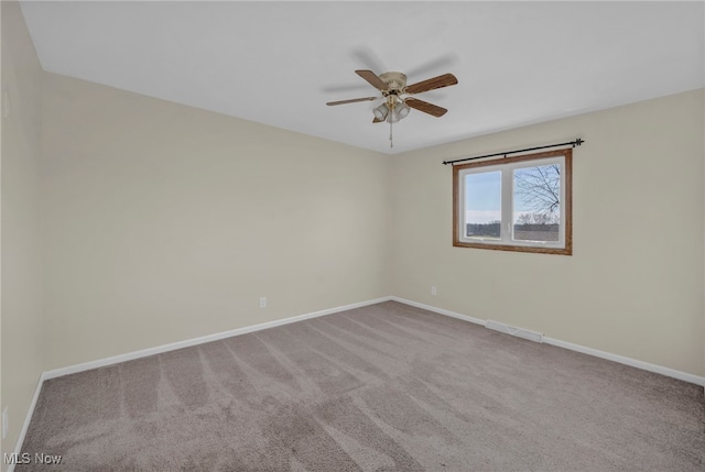 empty room featuring carpet flooring and ceiling fan