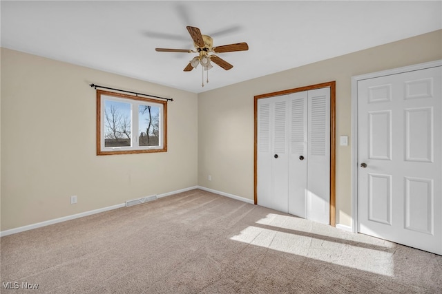 unfurnished bedroom with light carpet and ceiling fan