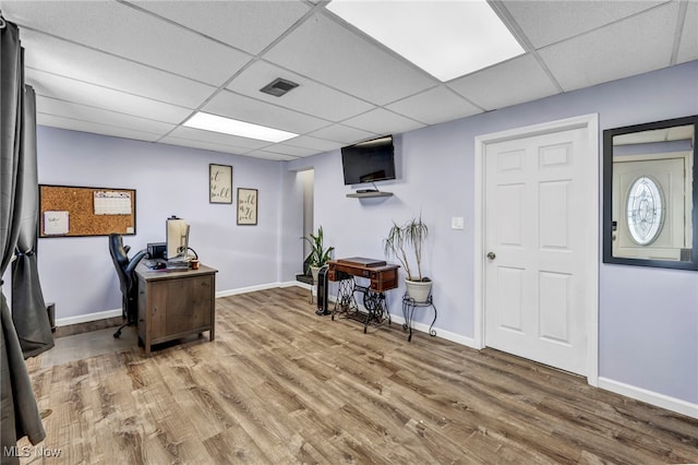 office area featuring a drop ceiling and wood-type flooring