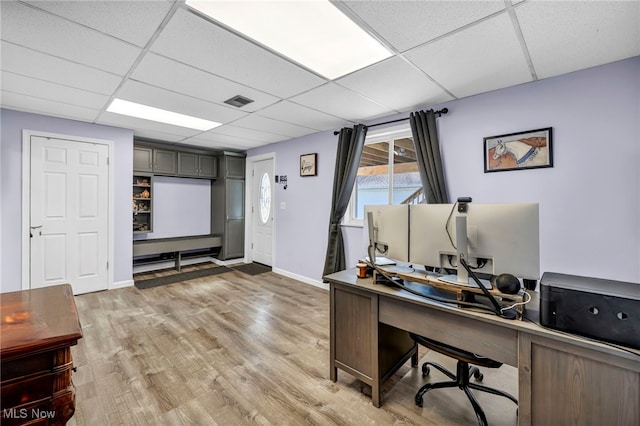 office featuring a drop ceiling and hardwood / wood-style flooring