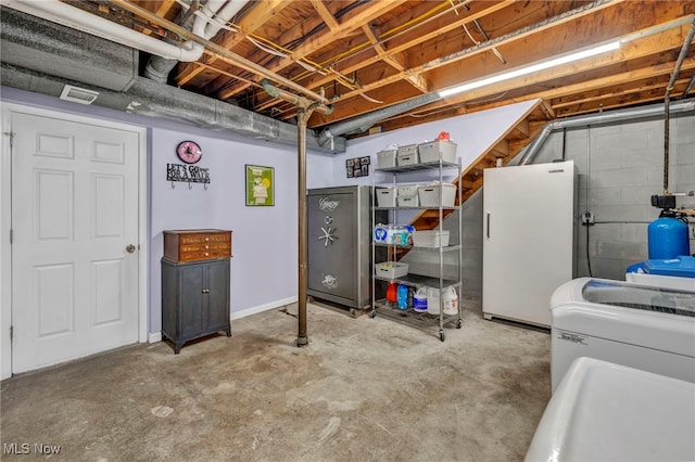 basement with white refrigerator