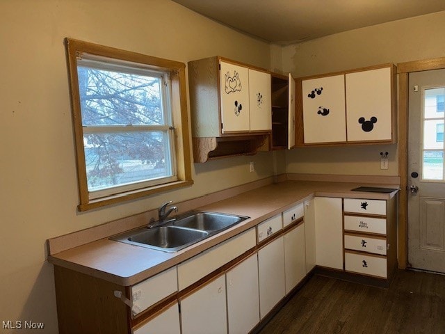 kitchen featuring dark hardwood / wood-style flooring, white cabinetry, plenty of natural light, and sink