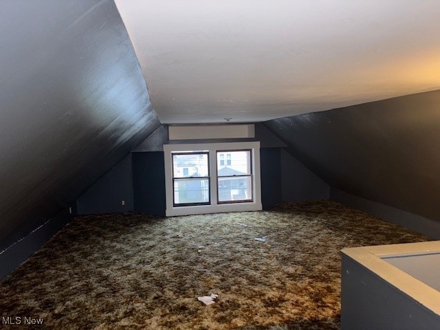 bonus room with carpet floors and lofted ceiling