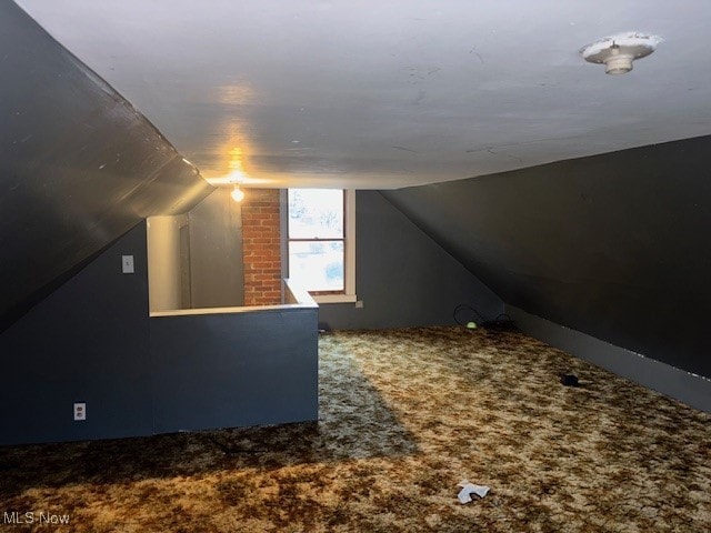 bonus room featuring carpet floors and lofted ceiling