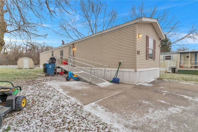 view of side of home with a storage unit