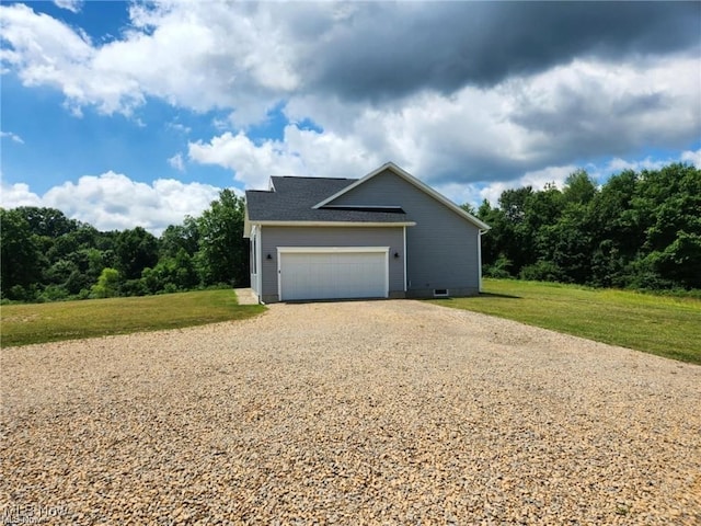 exterior space with a garage and a yard